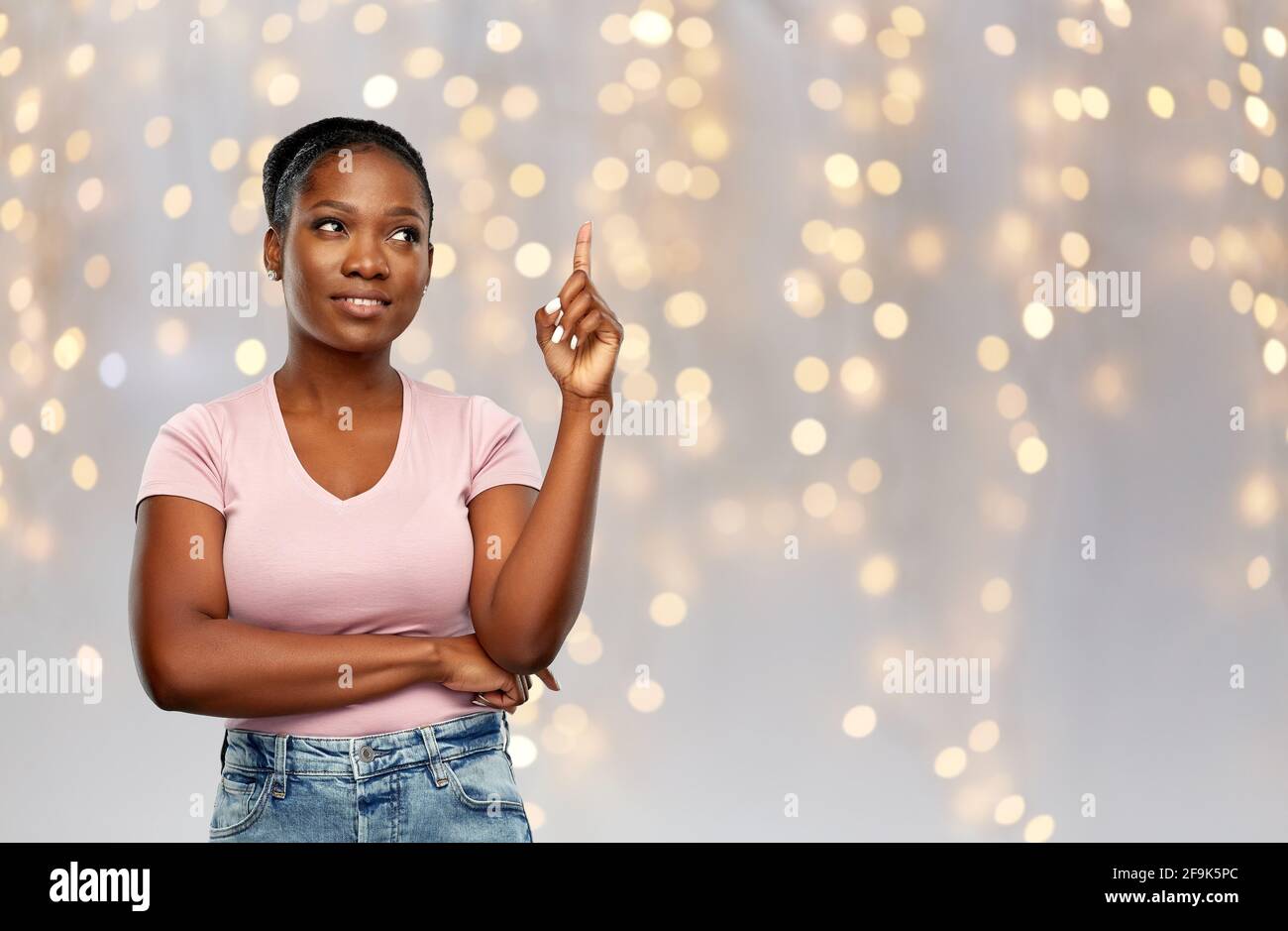happy african american woman pointing finger up Stock Photo - Alamy