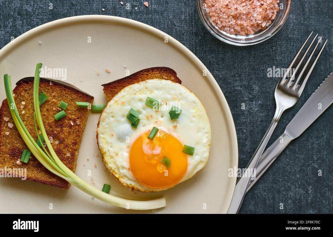 Fried rye bread with scrambled eggs, breakfast concept, top view Stock