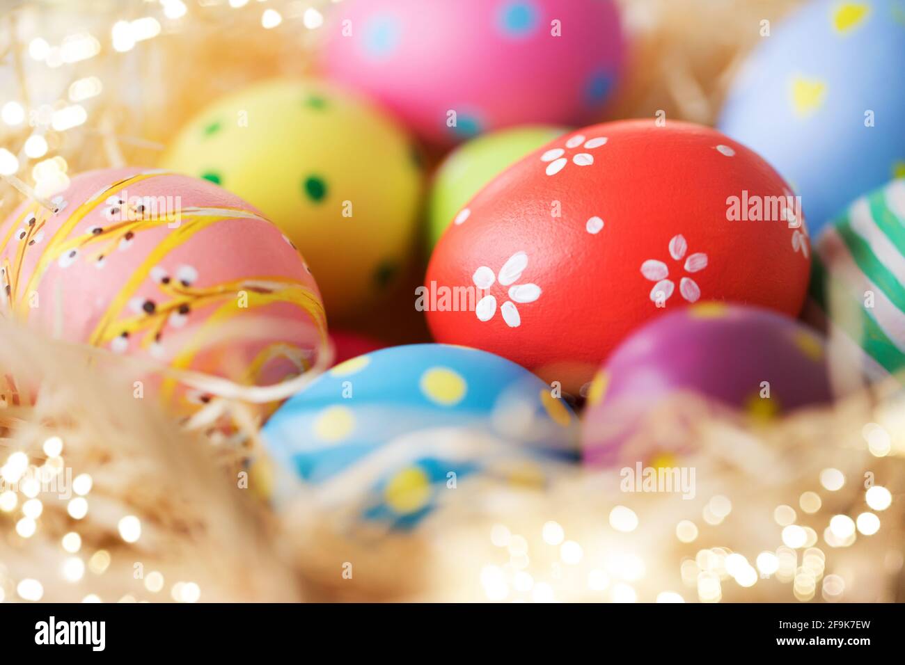 close up of colored easter eggs in straw Stock Photo - Alamy