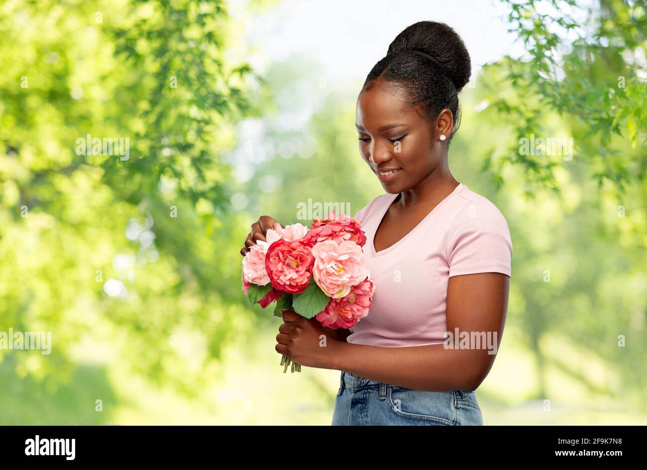 happy african american woman with bunch of flowers Stock Photo - Alamy