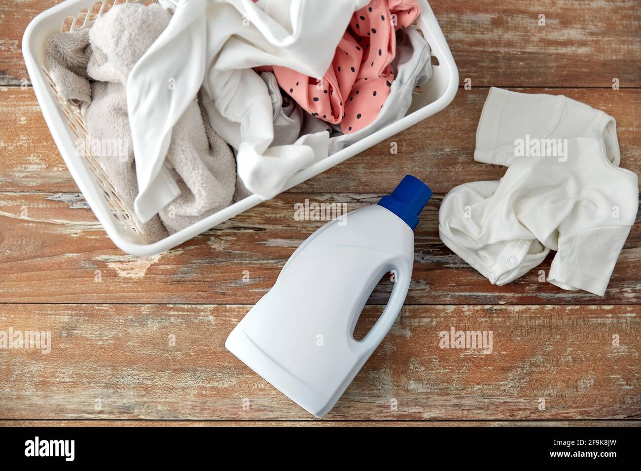 baby clothes in laundry basket with detergent Stock Photo - Alamy