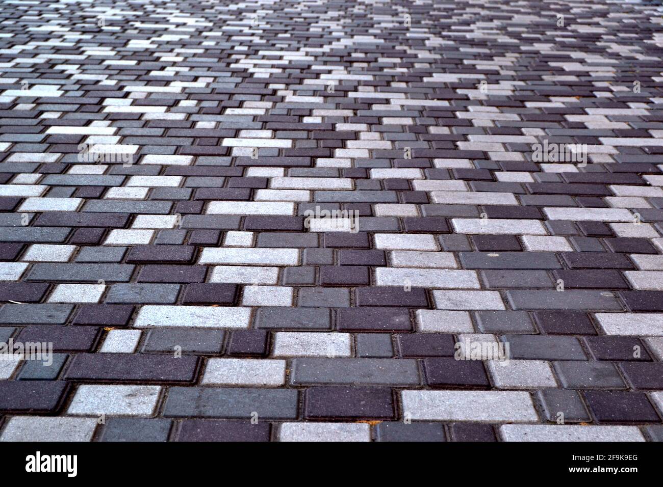 beautiful background laid paving slabs on pedestrian path. Monotonous pattern of multicolored