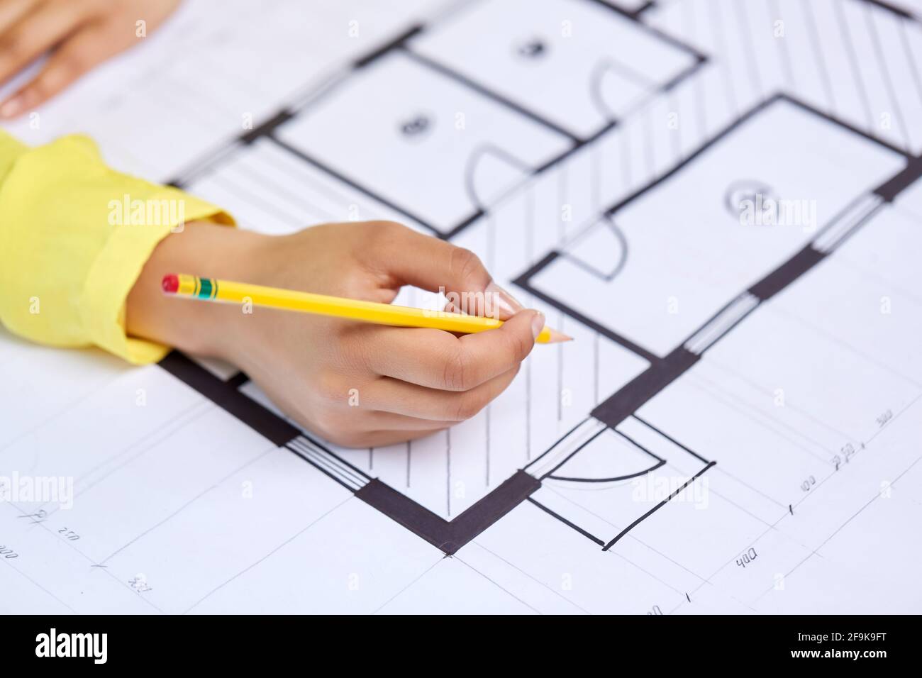 close up of architect's hand with blueprint Stock Photo