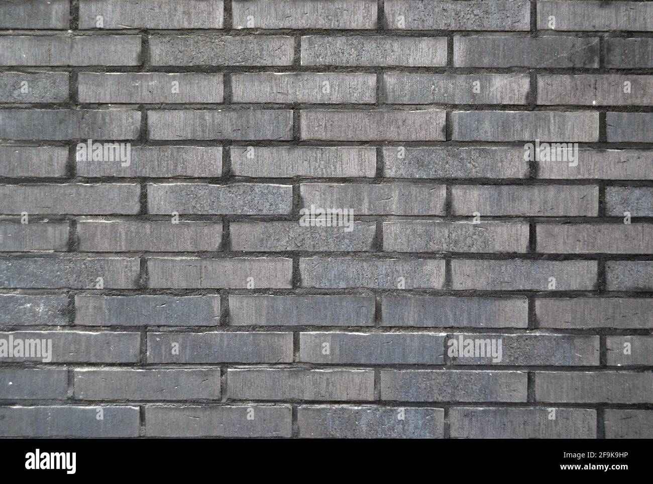 Dark grey brick wall texture. Abstract background or backdrop Stock