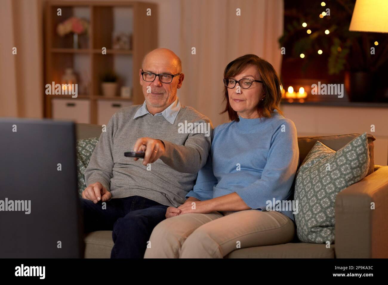 senior couple watching tv at home in evening Stock Photo
