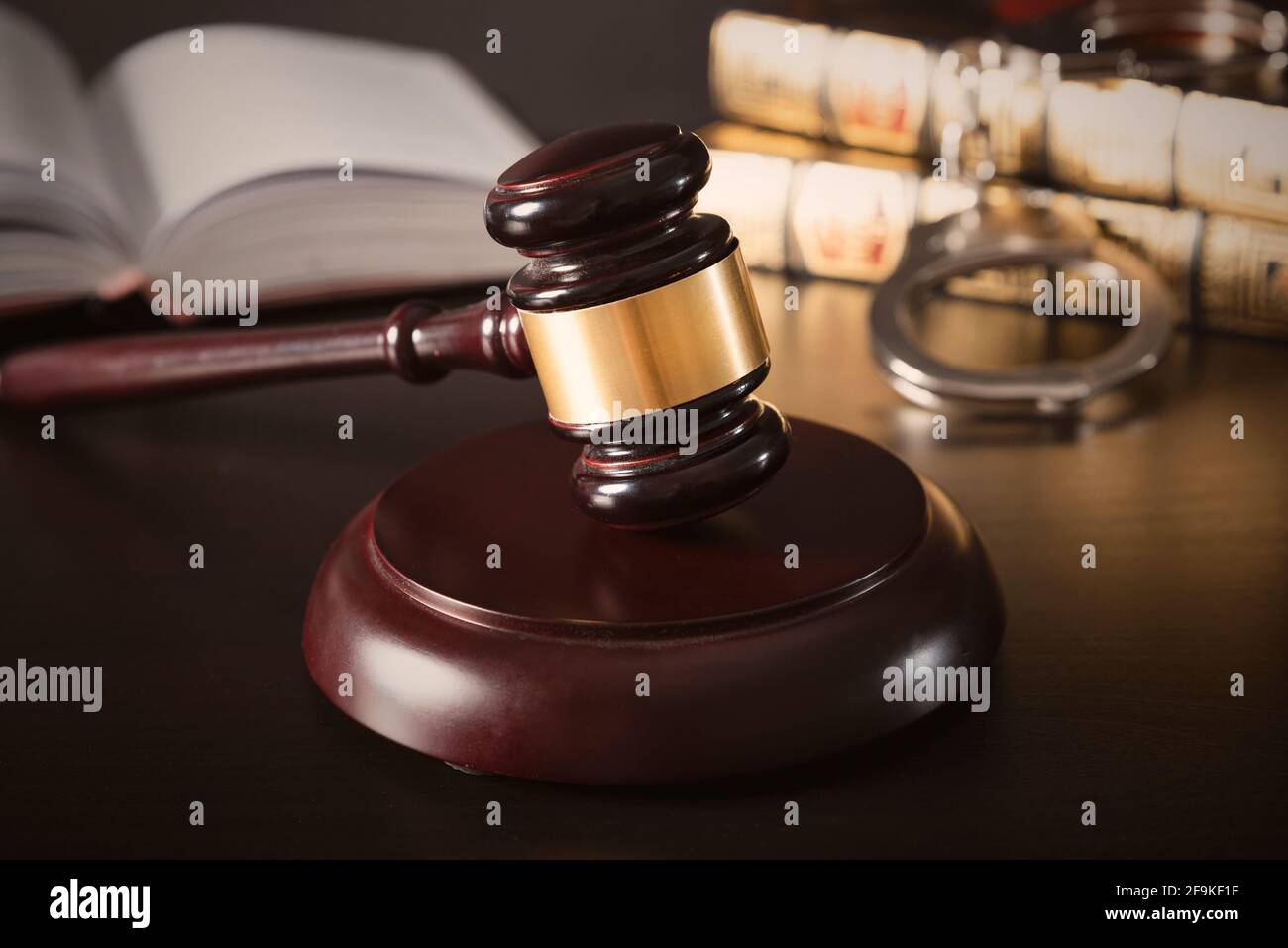 Judge gavel in court. Legal and justice concept. Library, books and handcuffs Stock Photo