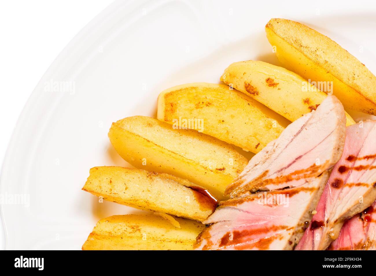 Baked potato wedges and grilled tuna fillet. Macro. Photo can be used