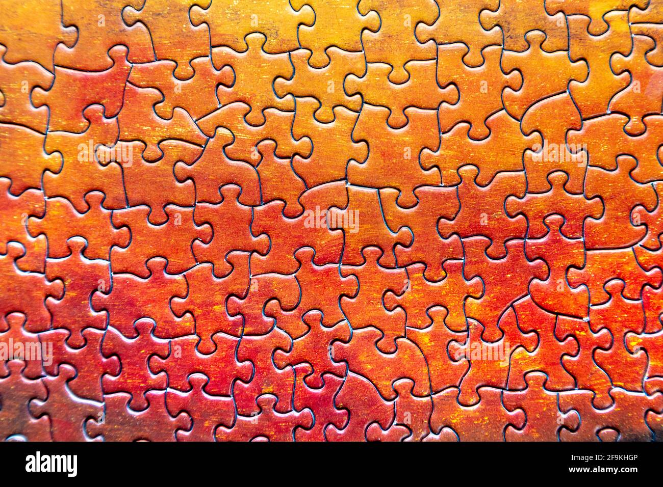 Vibrant orange and red jigsaw puzzle pieces background Stock Photo