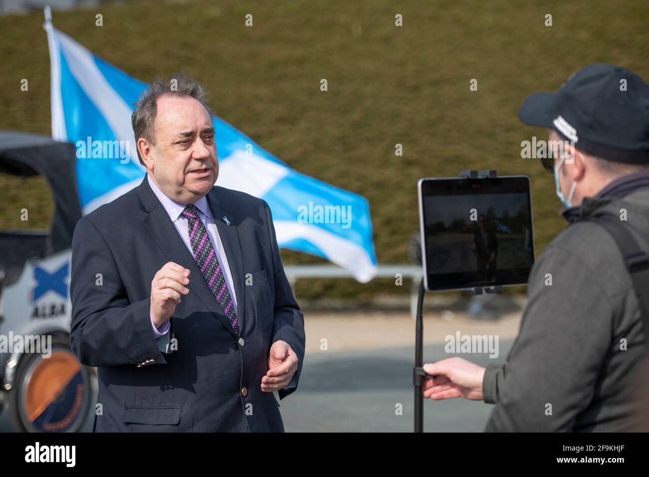 Glasgow, Scotland, UK. 19 April 2021. PICTURED: Alex Salmond Leader of the Alba Party (seen during media interviews) marks the start of the ALBA Glasgow campaign with ALBA Glasgow Candidates: Cllr Michelle Ferns, Ailsa Gray, Cllr Shahid Farooq and Lynn McMahon. Mr Salmond will outline ALBA's plans to enhance the Educational Maintenance Allowance and Cllr Ferns will set out how ALBA intend to provide Financial support to taxi drivers and private hire drivers. Speaking in advance of the Photo call ALBA Party Leader Alex Salmond said: “ Today we are announcing targeted measures to support y Stock Photo