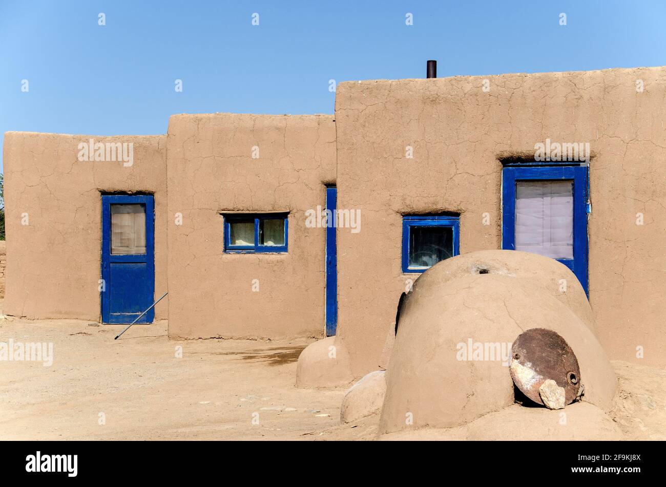 Taos Pueblo is a thousand years old adobe village at the foot of the Sangre de Christo mountains of northern New Mexico, USA. It is a UNESCO World Her Stock Photo