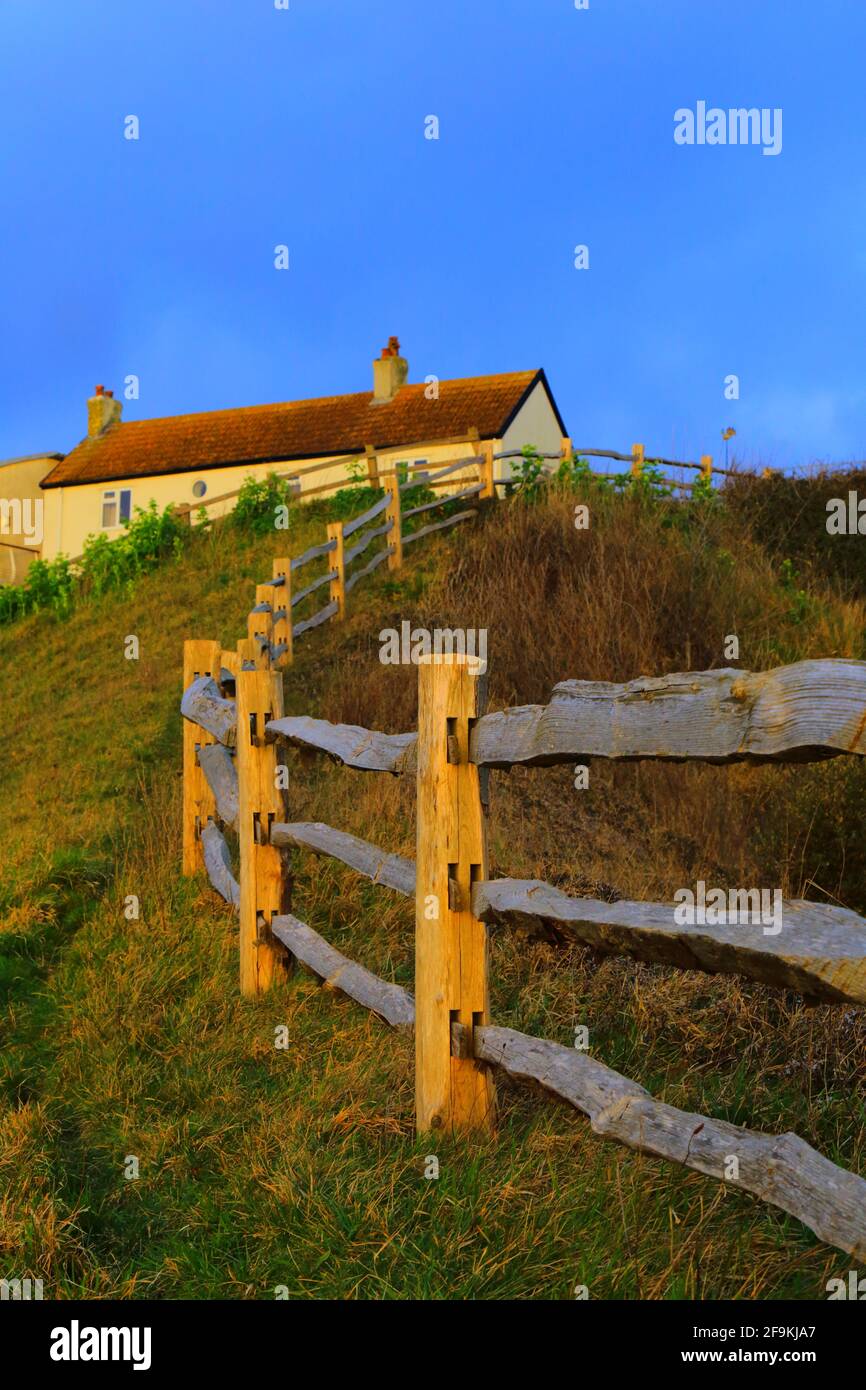 Wooden fence and house on the hill Stock Photo