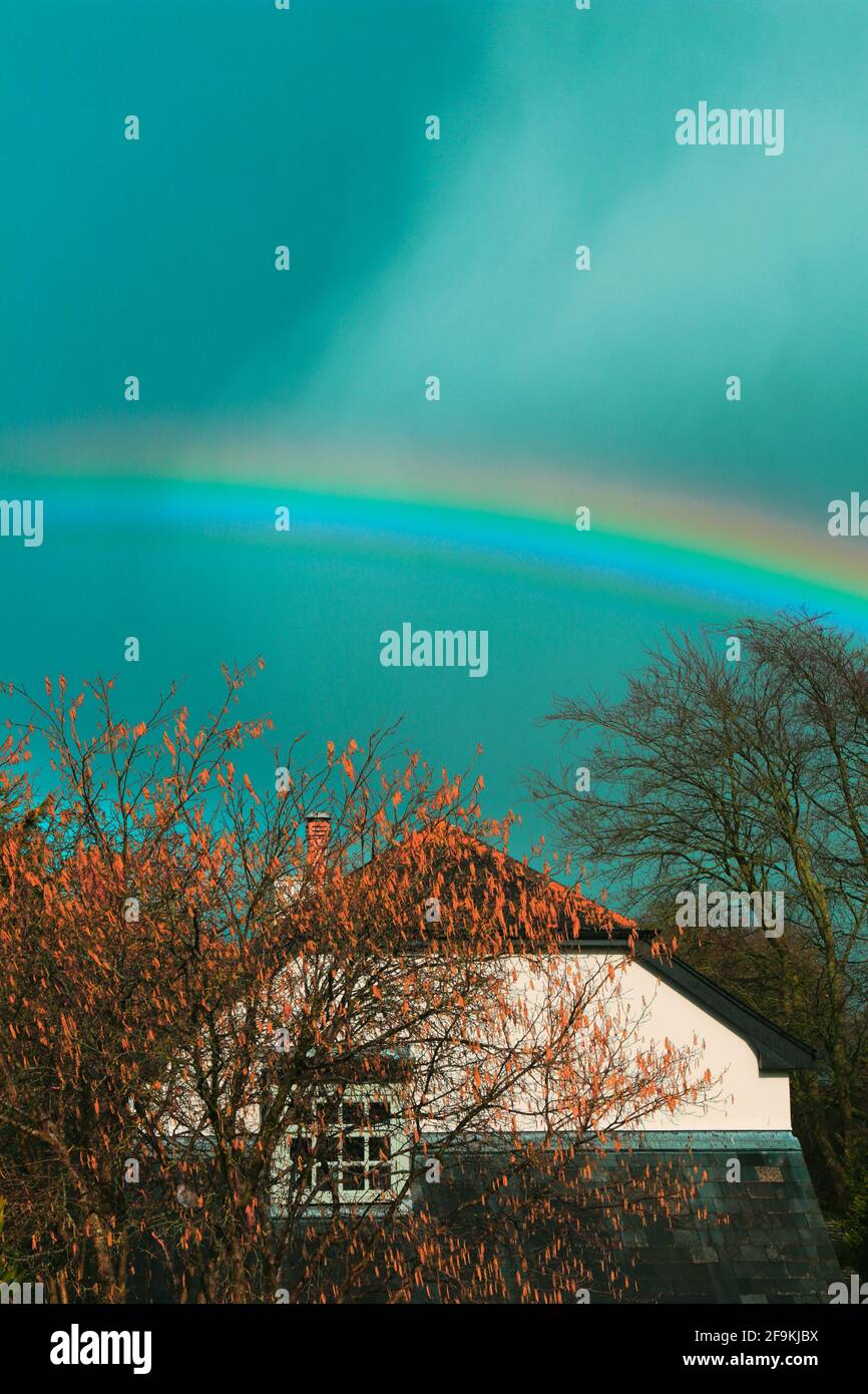 Rainbow above house Stock Photo