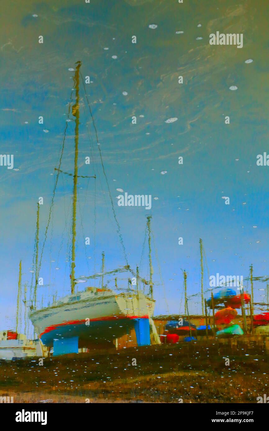 Sailing boats reflected on the water Stock Photo