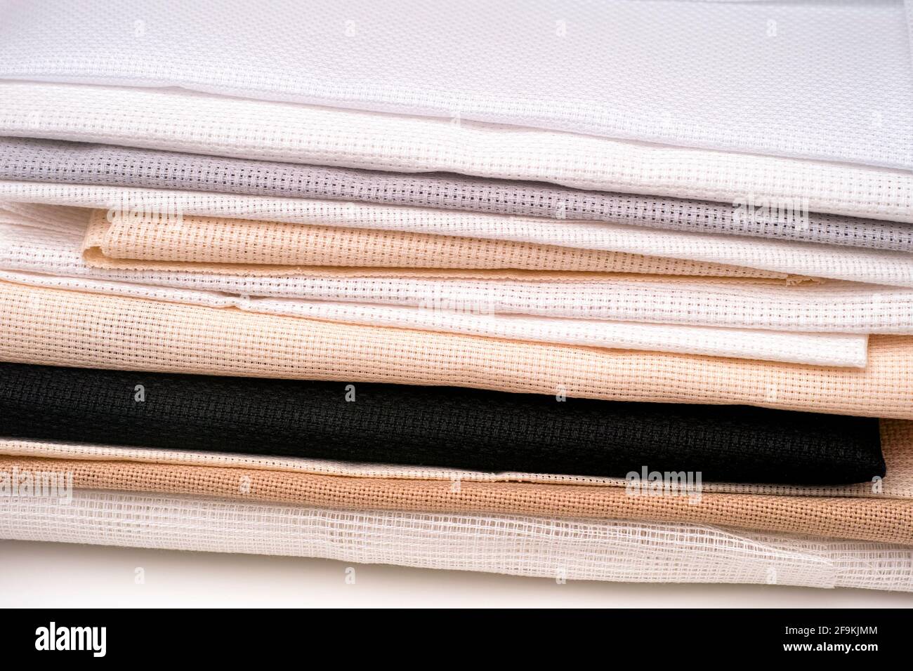 Colour cross stitch canvas in stack Stock Photo - Alamy