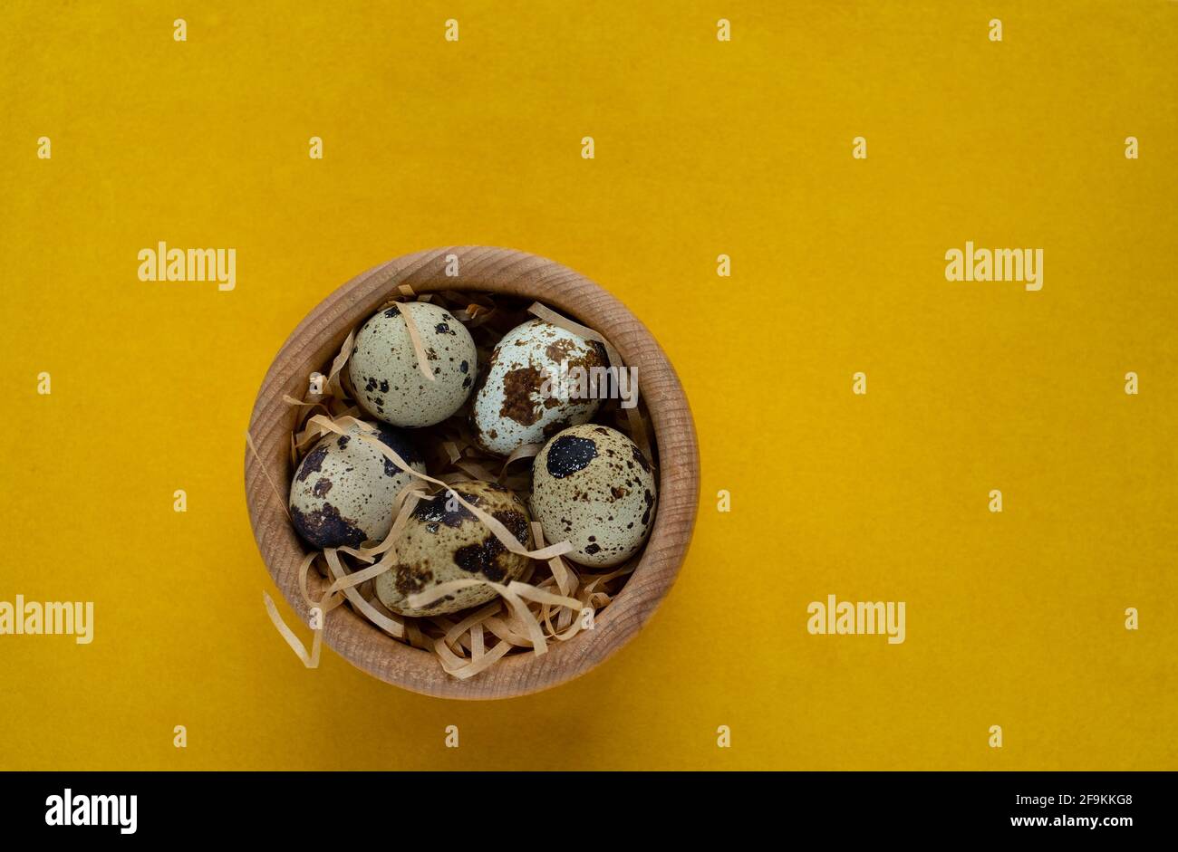 Happy Easter. Quail eggs in the wooden basket, selective focus Stock Photo
