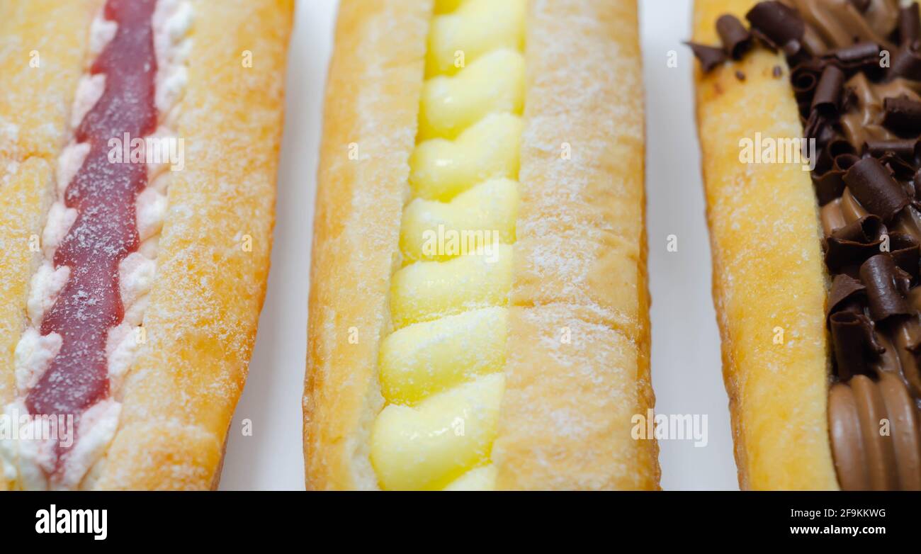 Mixed finger donuts filling chocolate, custard, jam and whipped cream
