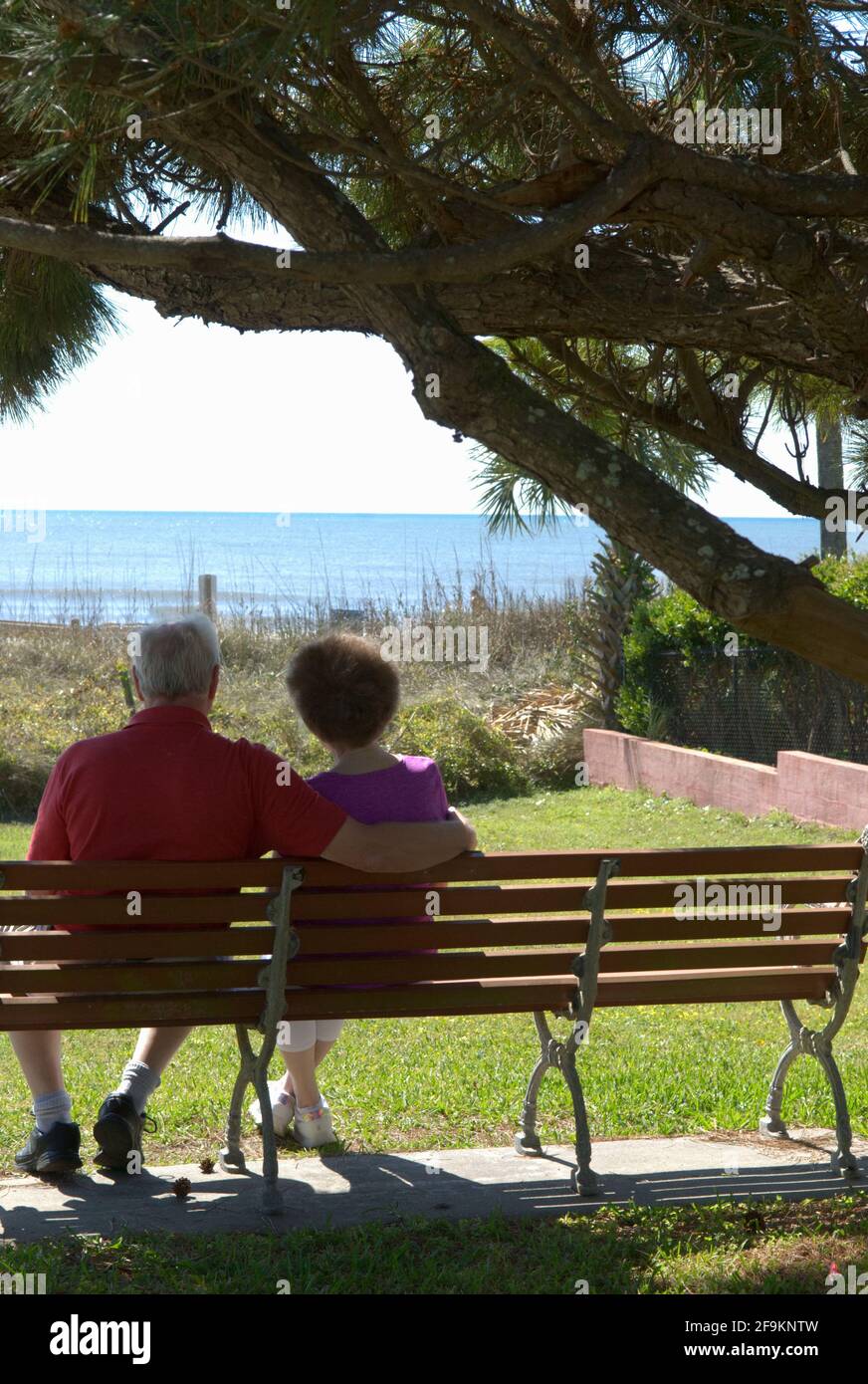 Caucasian senior couple (age 60-70) Sitting and Enjoying View  at Myrtle Beach South Carolina USA. Stock Photo