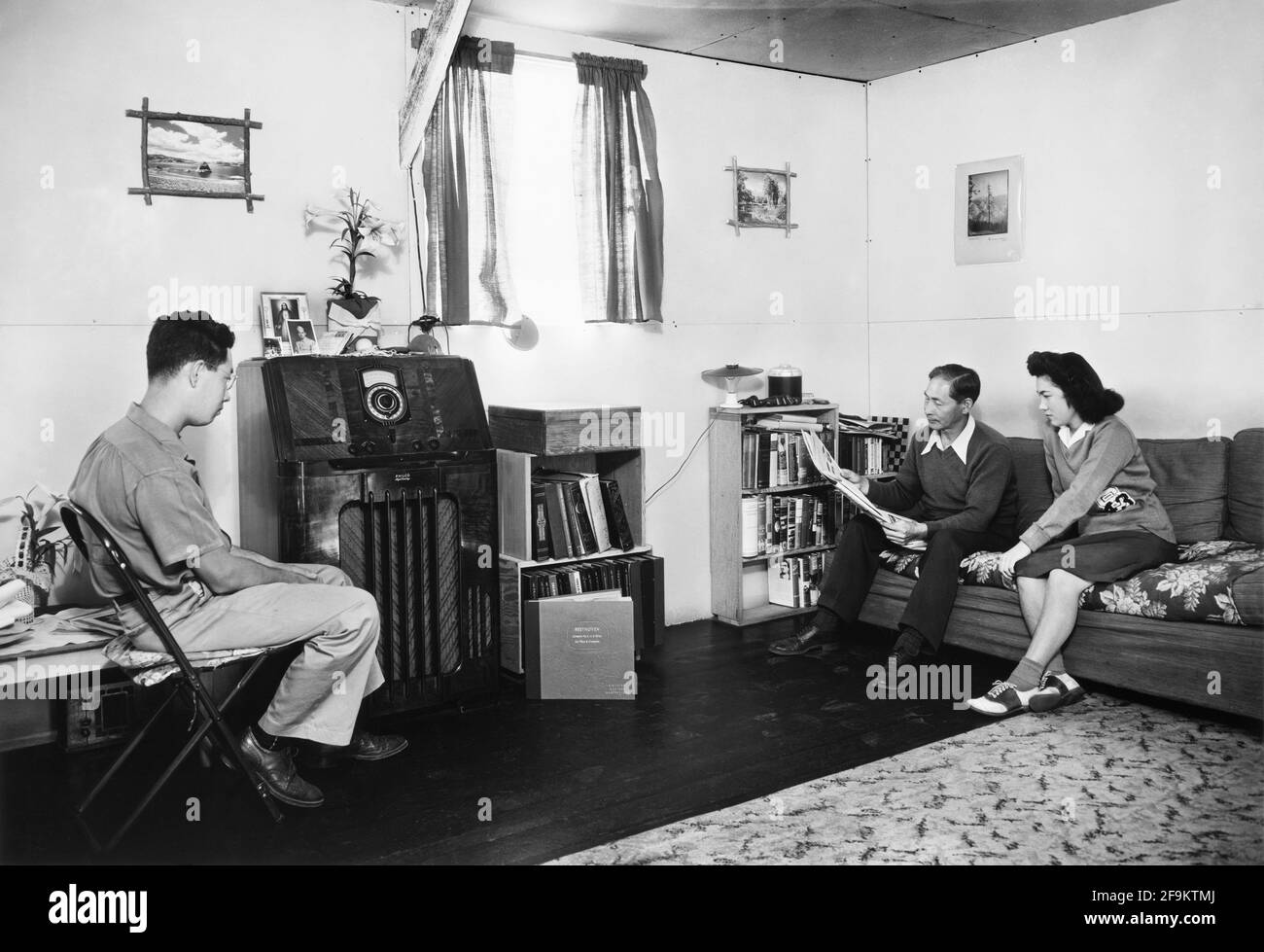 Francis Yonemitsu with Daughter Lucy and Son Michael, in their Living Room, Manzanar Relocation Center, California, USA, Ansel Adams, Manzanar War Relocation Center Collection, 1943 Stock Photo