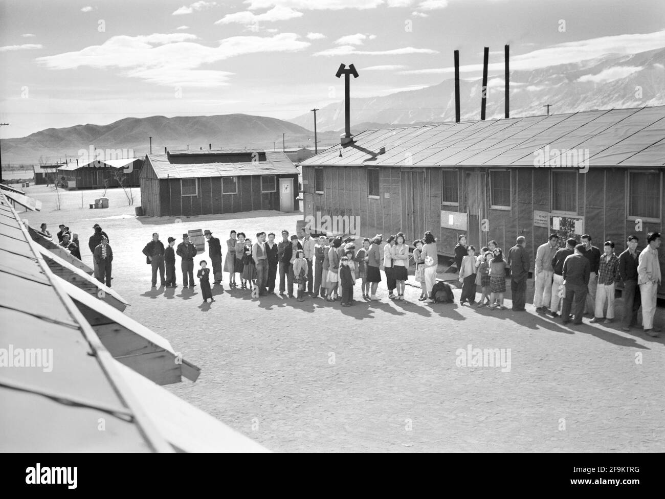 Japanese-Americans waiting in line at Mess Hall, Manzanar Relocation Center, California, USA, Ansel Adams, Manzanar War Relocation Center Collection, 1943 Stock Photo