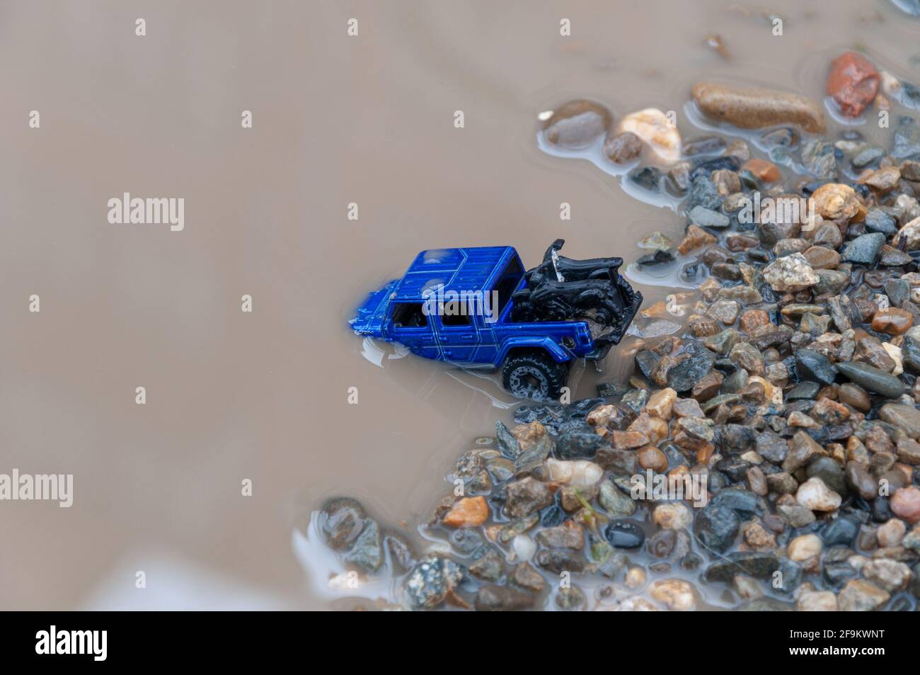 Car crosses river. Car submerged in flood water. Flood Insurance concept image. Driving through