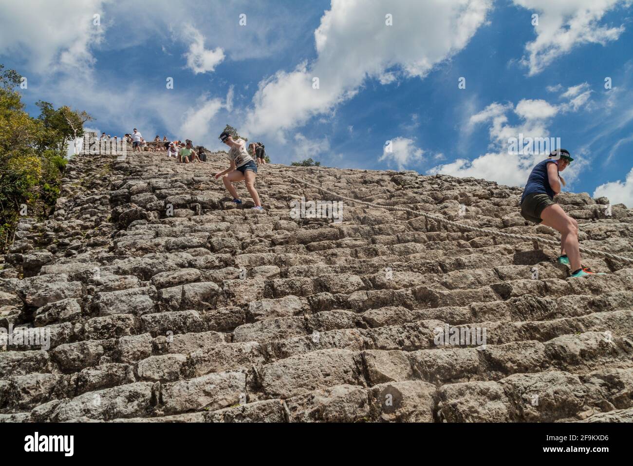 COBA, MEXICO - MARCH 1, 2016: Tourist climb the Pyramid Nohoch Mul at the ruins of the Mayan city Coba, Mexico Stock Photo