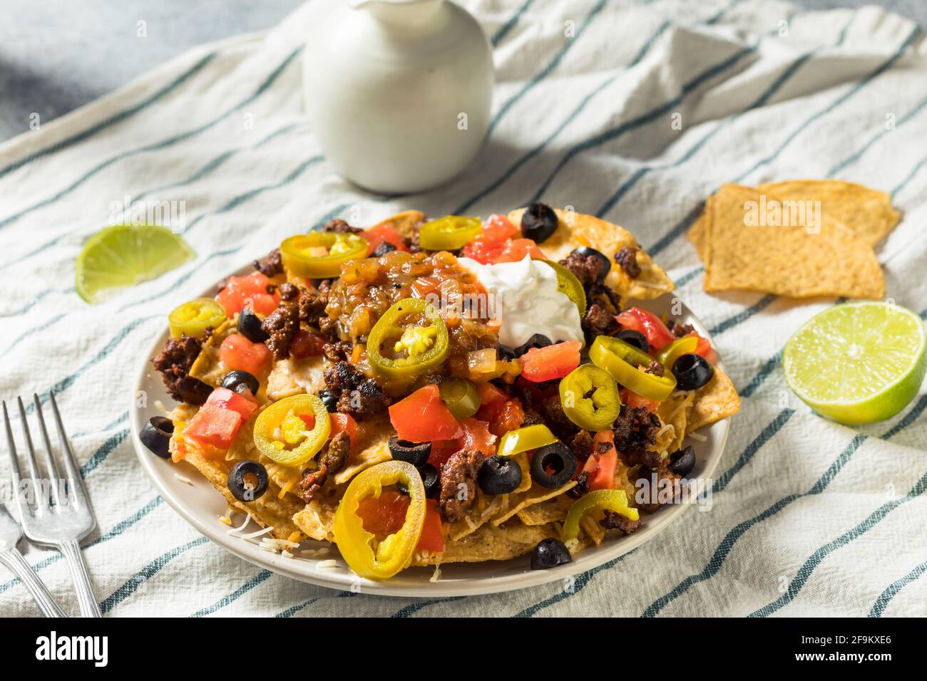 Homemade Cheesy Beef Nachos with Olives and Jalapenos Stock Photo Alamy