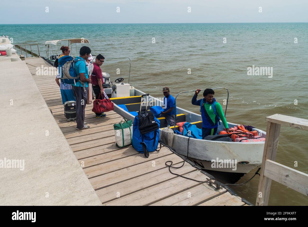 PUNTA GORDA, BELIZE - MARCH 9, 2016: Passengers boarding a boat to Livingston Guatemala in a port of Punta Gorda town, Belize Stock Photo