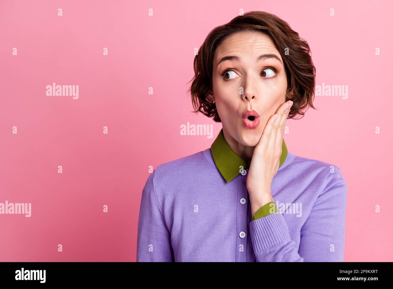 Photo of astonished girl look copyspace touch hand face wear violet ...