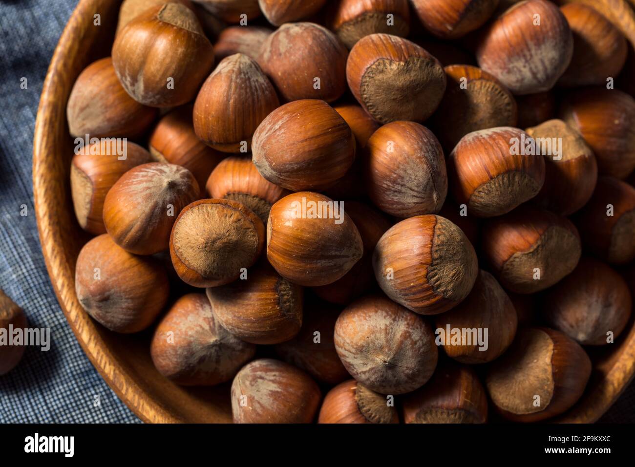 Raw Organic Unshelled Hazelnuts in a Bowl Stock Photo