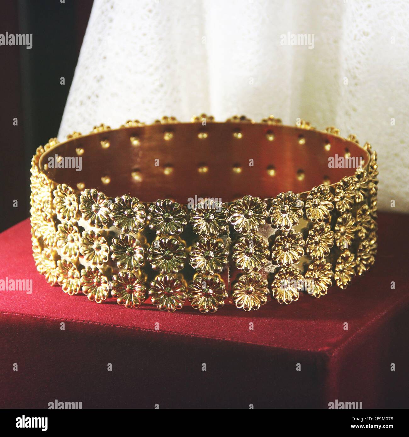 Golden crown on a red background Stock Photo - Alamy