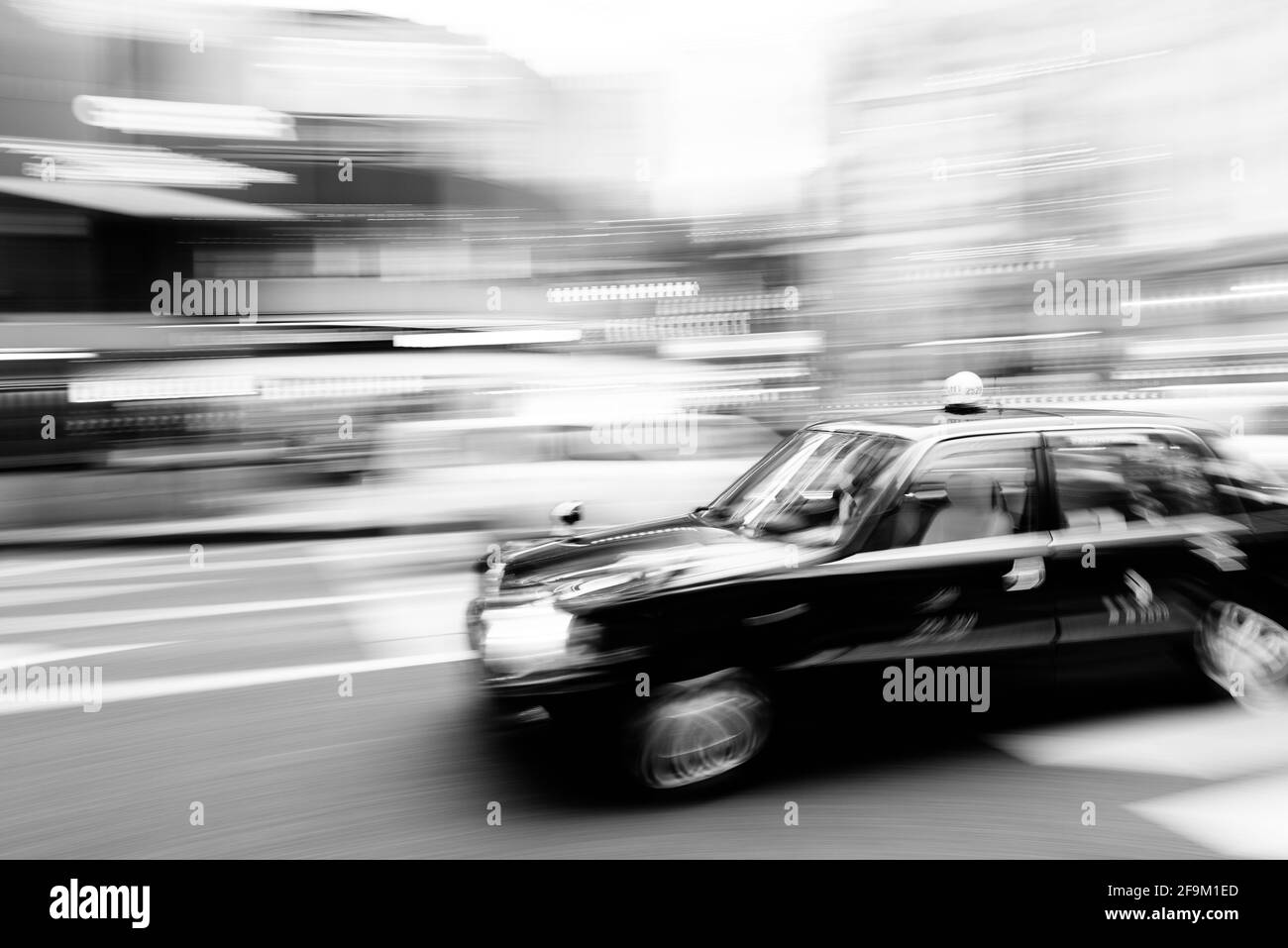Tokyo, Japan - December 10, 2015: : Motion blurred taxi at the heart of Ginza District in Tokyo. Stock Photo