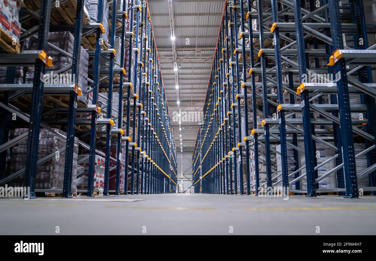 Logistics center interior full of racks with with large number packs. Stock Photo