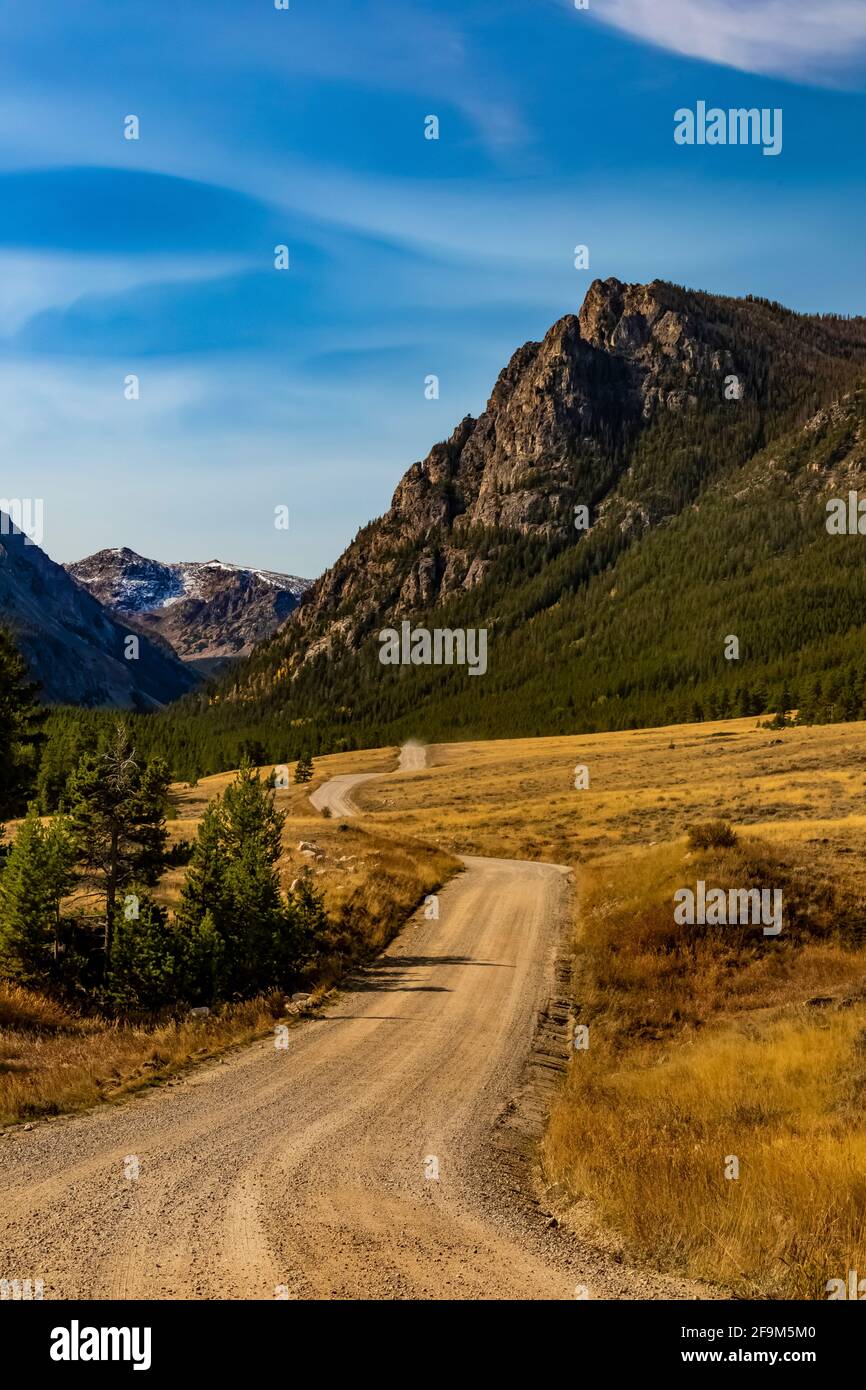 Gravel road winding through Rock Creek Valley in the Beartooth Mountains, Beartooth Highway, Montana, USA Stock Photo