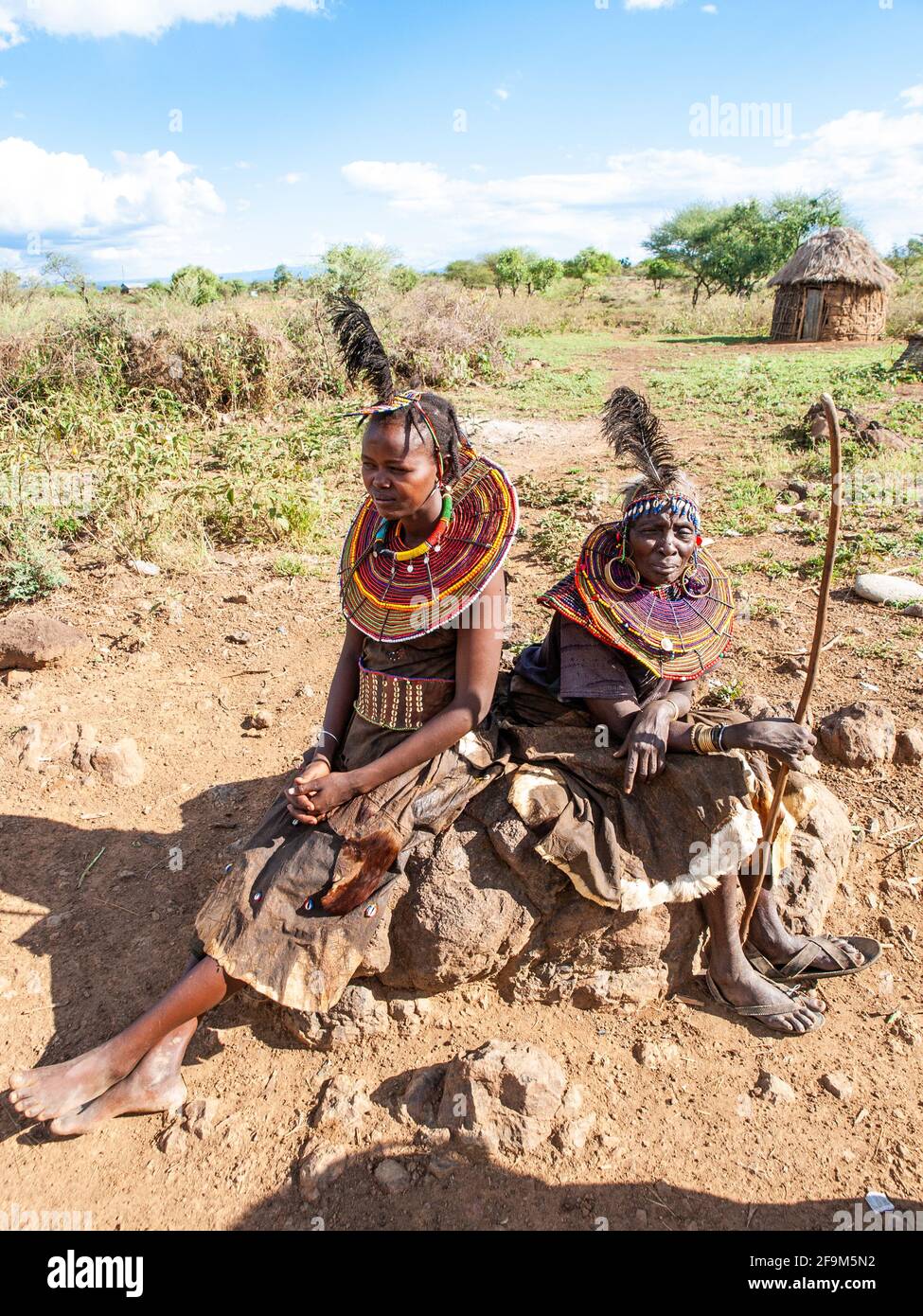 Native women in traditional garb, posing in village. The Pokot people ...