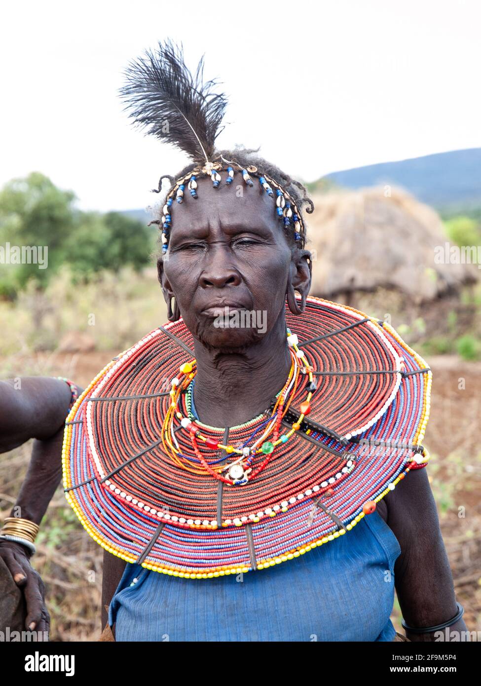 Native woman in traditional garb,  posing in village. The Pokot people (also spelled Pökoot) live in West Pokot County and Baringo County in Kenya Stock Photo