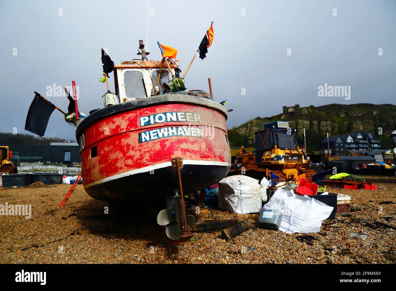 Pioneer fishing boat from Newhaven on The Stade shingle beach below East Hill Cliff, Hastings, East Sussex, England, UK Stock Photo