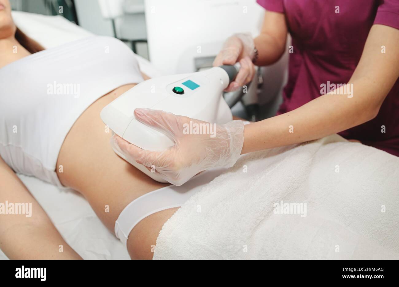 Attractive woman in white bikini getting Cool sculpting procedure for body slimming. Cryolipolyse and body contouring treatment, anti-cellulite Stock Photo
