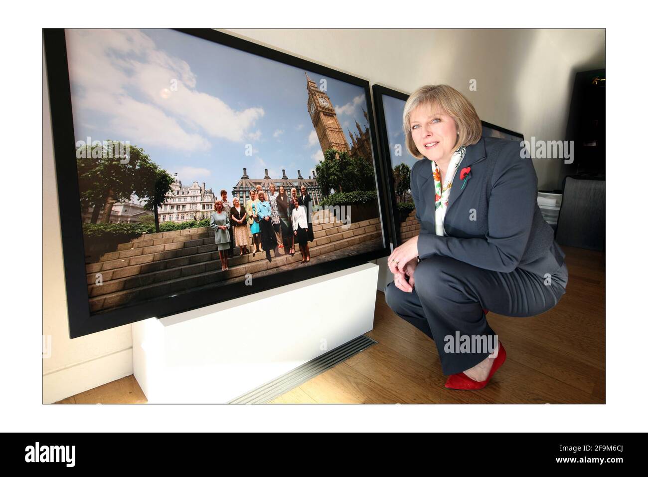 Four photographic images, of 104 of the 125 women MPs in Westminster were launched at the Portrait Gallery in London. The images shot by Kieran Doherty are to mark 90 years since women were first given the vote.Theresa May MP views one of the images. photograph by David Sandison The Independent Stock Photo