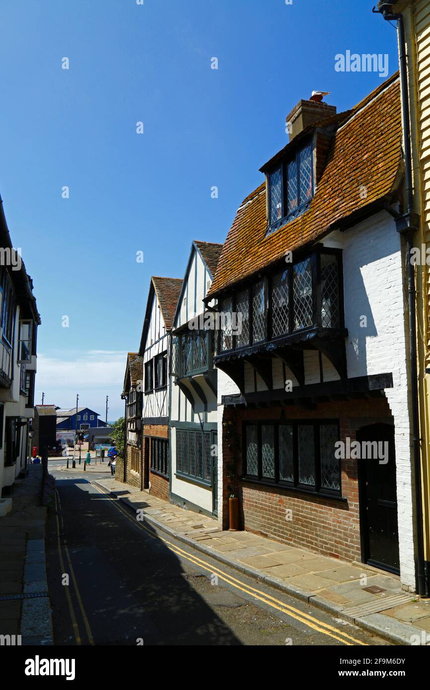 Quaint historic timber framed houses in All Saints Street in Old Town, looking towards the coast, Hastings, East Sussex, England Stock Photo
