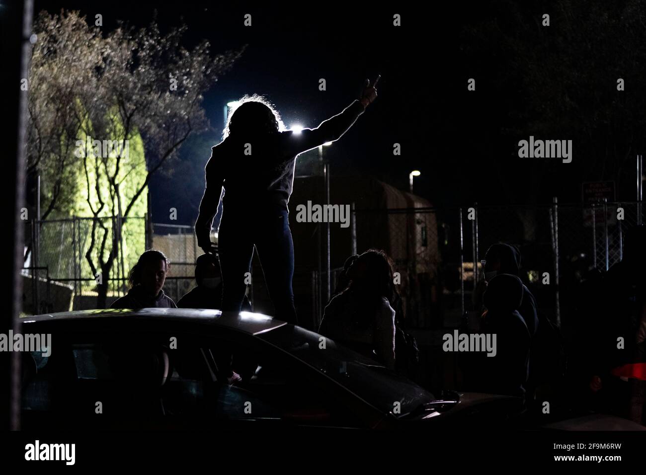 Road conflict. Woman showing middle finger and jeering someone outside her  car. Photos