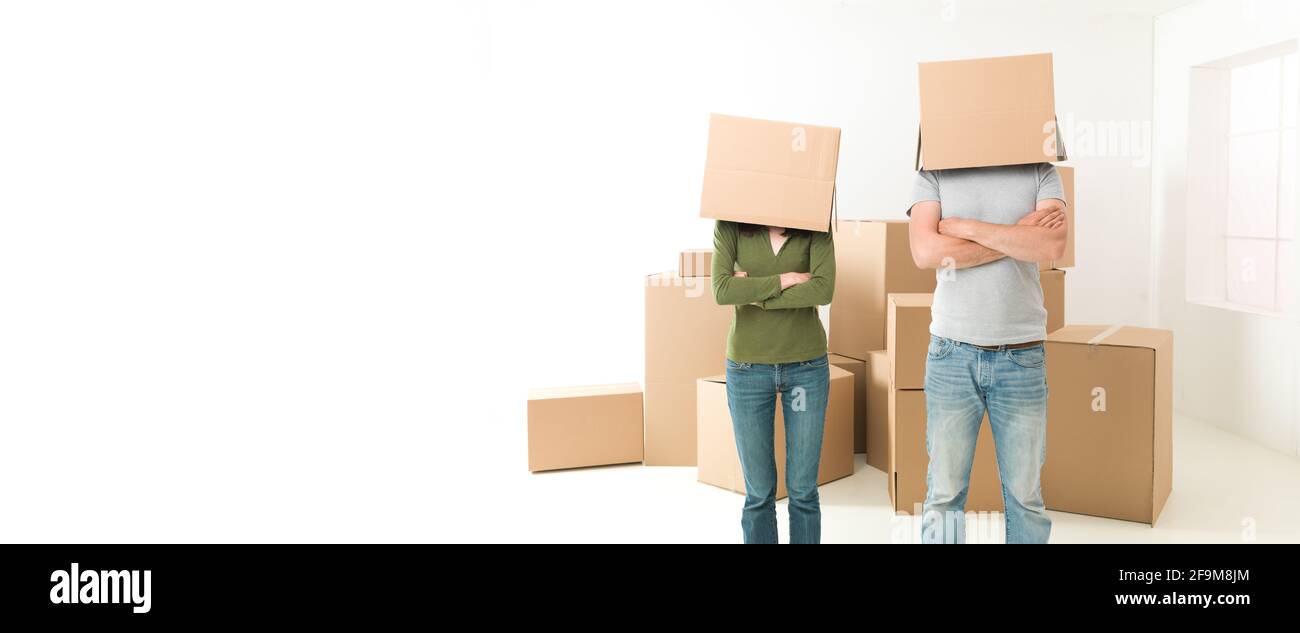 Couple With Boxes On Their Heads Standing In Their New House Arms couple-with-boxes-on-their-heads-standing-in-their-new-house-arms