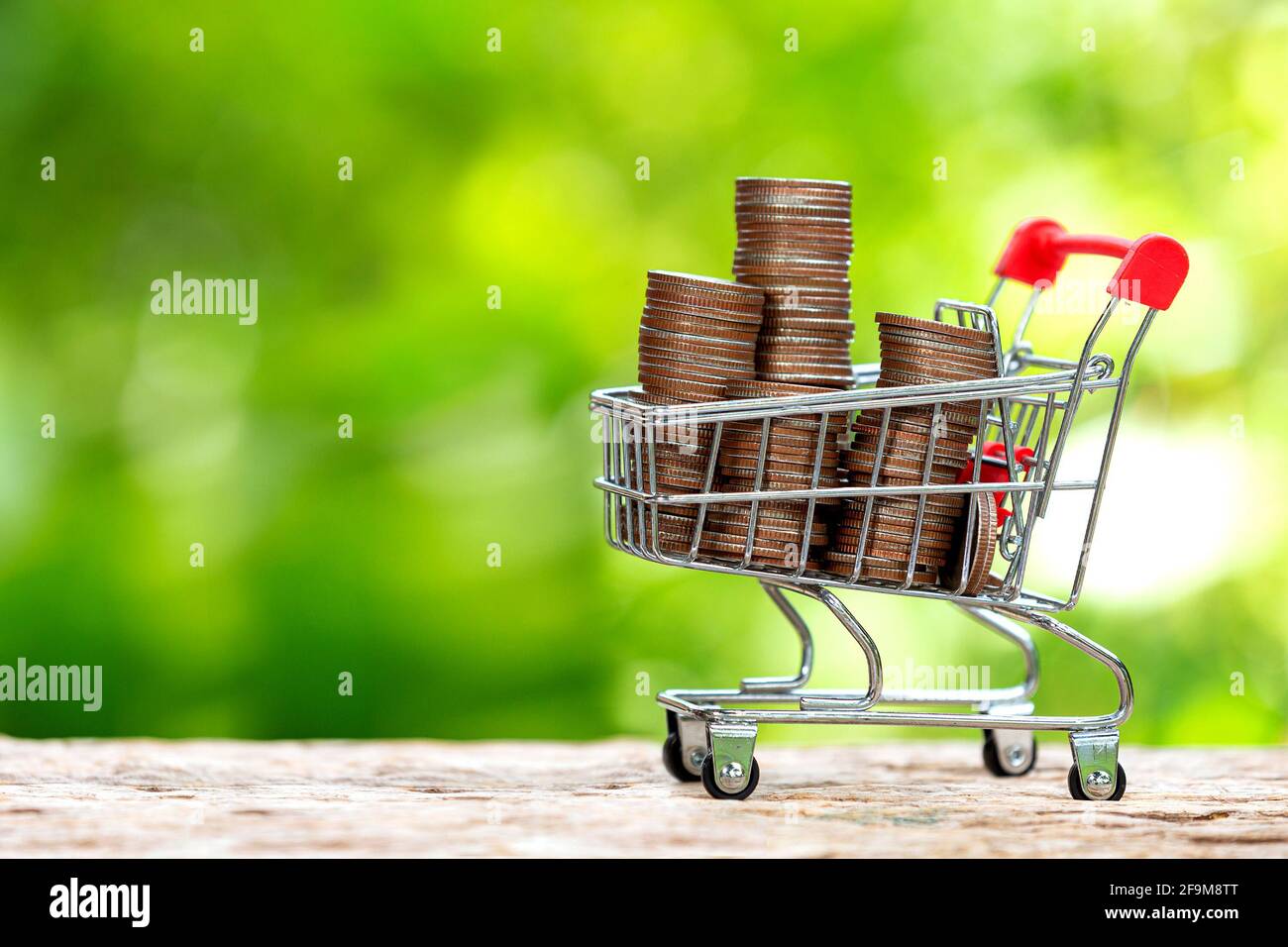 stack of coins in a shopping cart Stock Photo