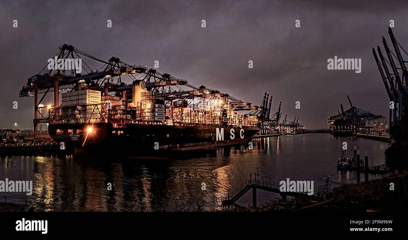 A modern container ship loading in the port of Hamburg Stock Photo