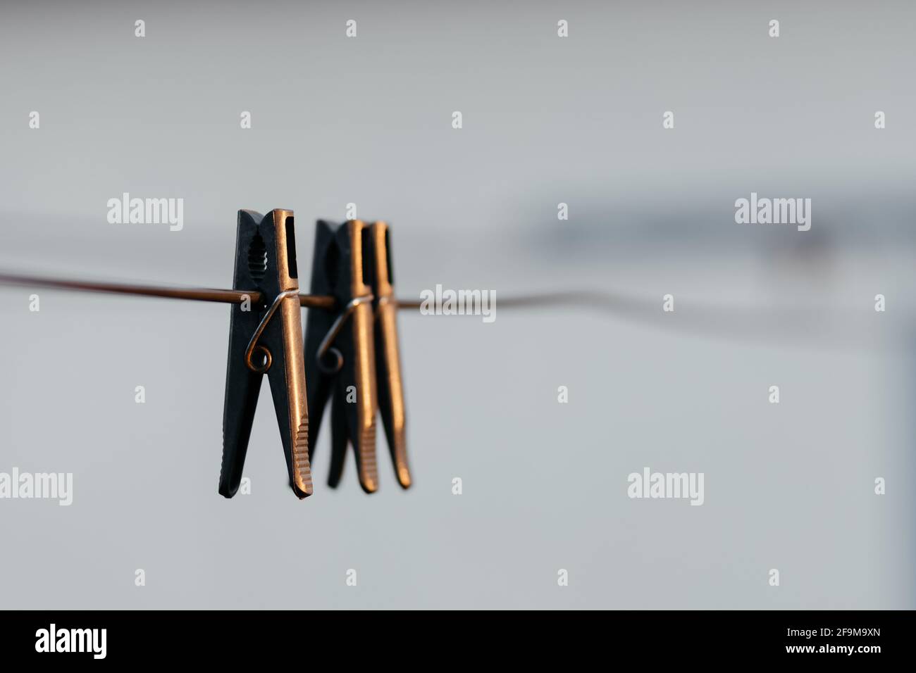 Black clothespins hanging from the clothesline close up Stock Photo Alamy