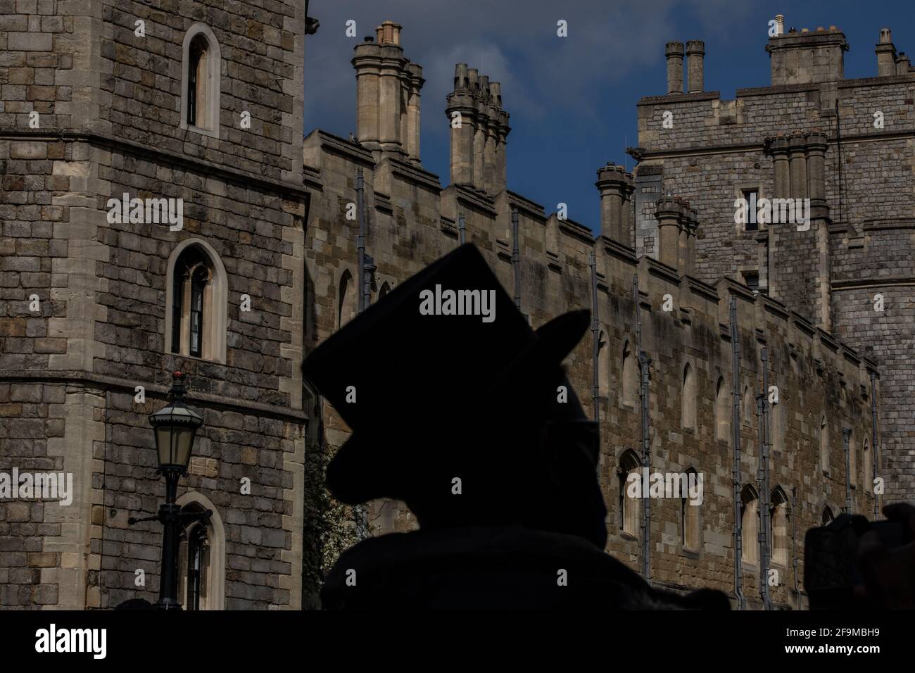 Man silhouetted wearing a Top Hat during UK Royal Funeral in Windsor: The build up to Duke of Edinburgh's Funeral in Windsor, Berkshire, England, UK Stock Photo