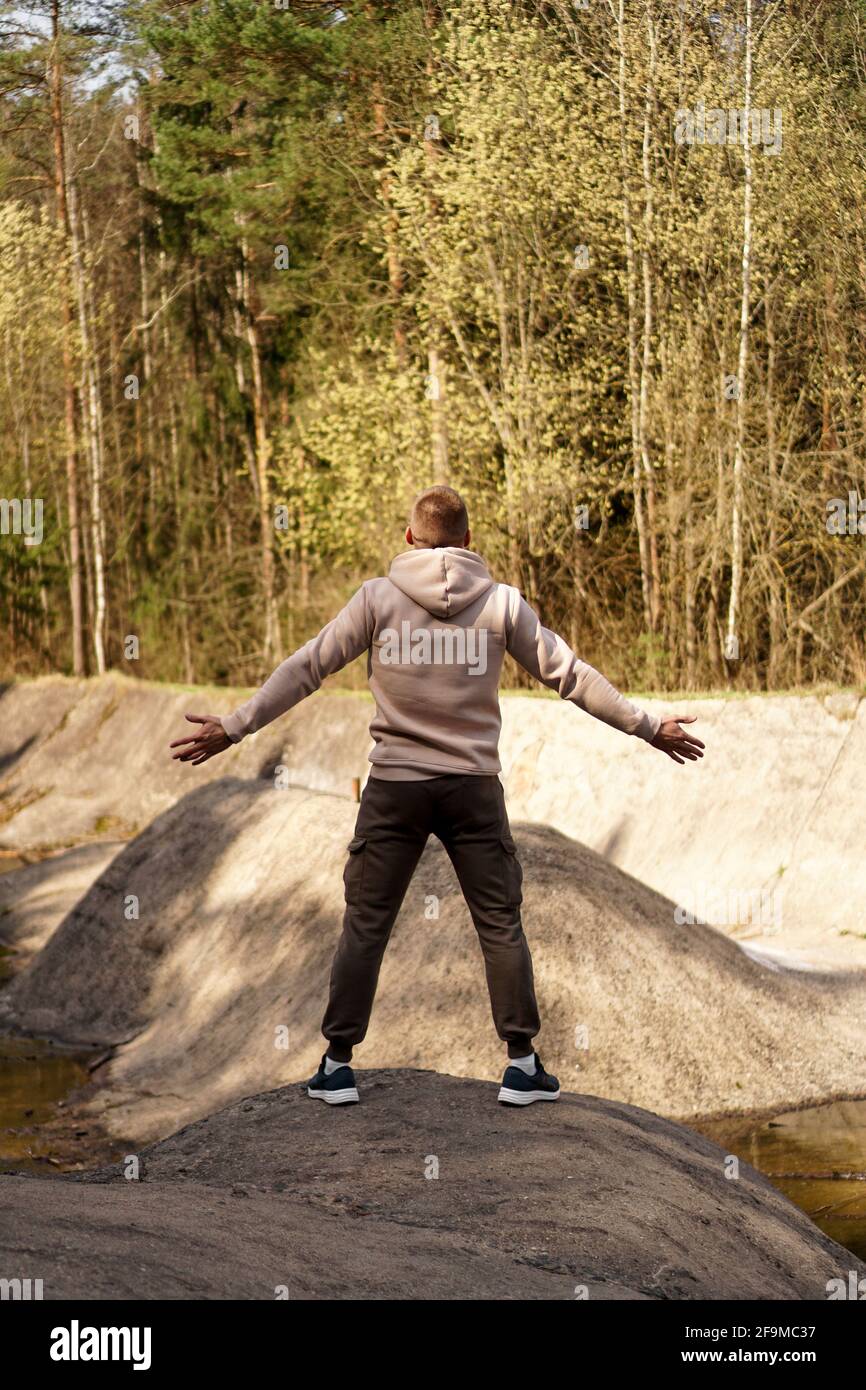 Young man hiking stands arms hi-res stock photography and images - Alamy