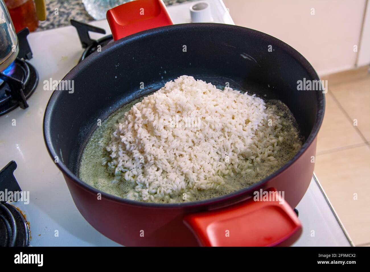 Rice grains to be roasted in pots Stock Photo Alamy