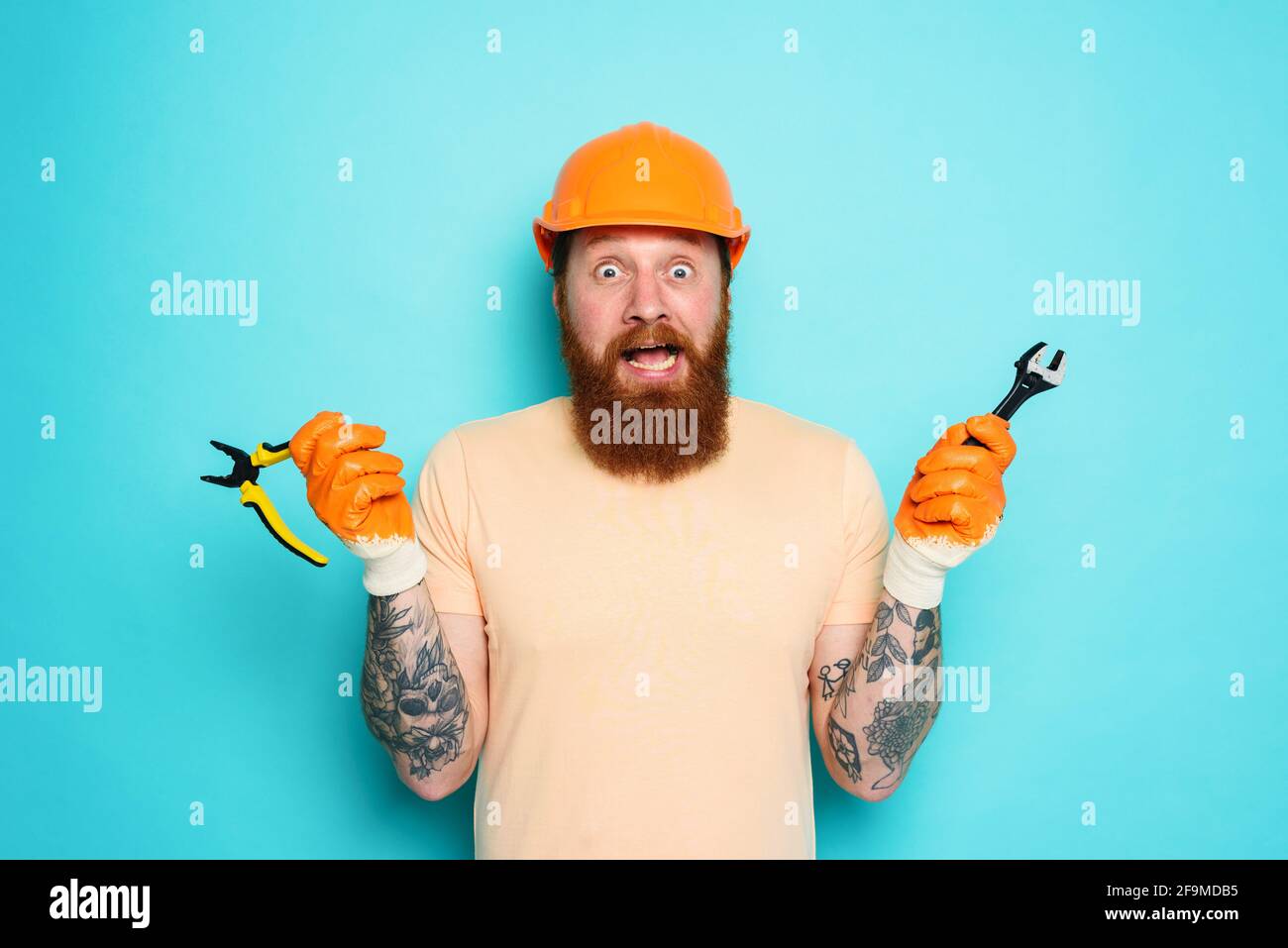 Incompetent worker is unsure about his work. cyan background Stock Photo