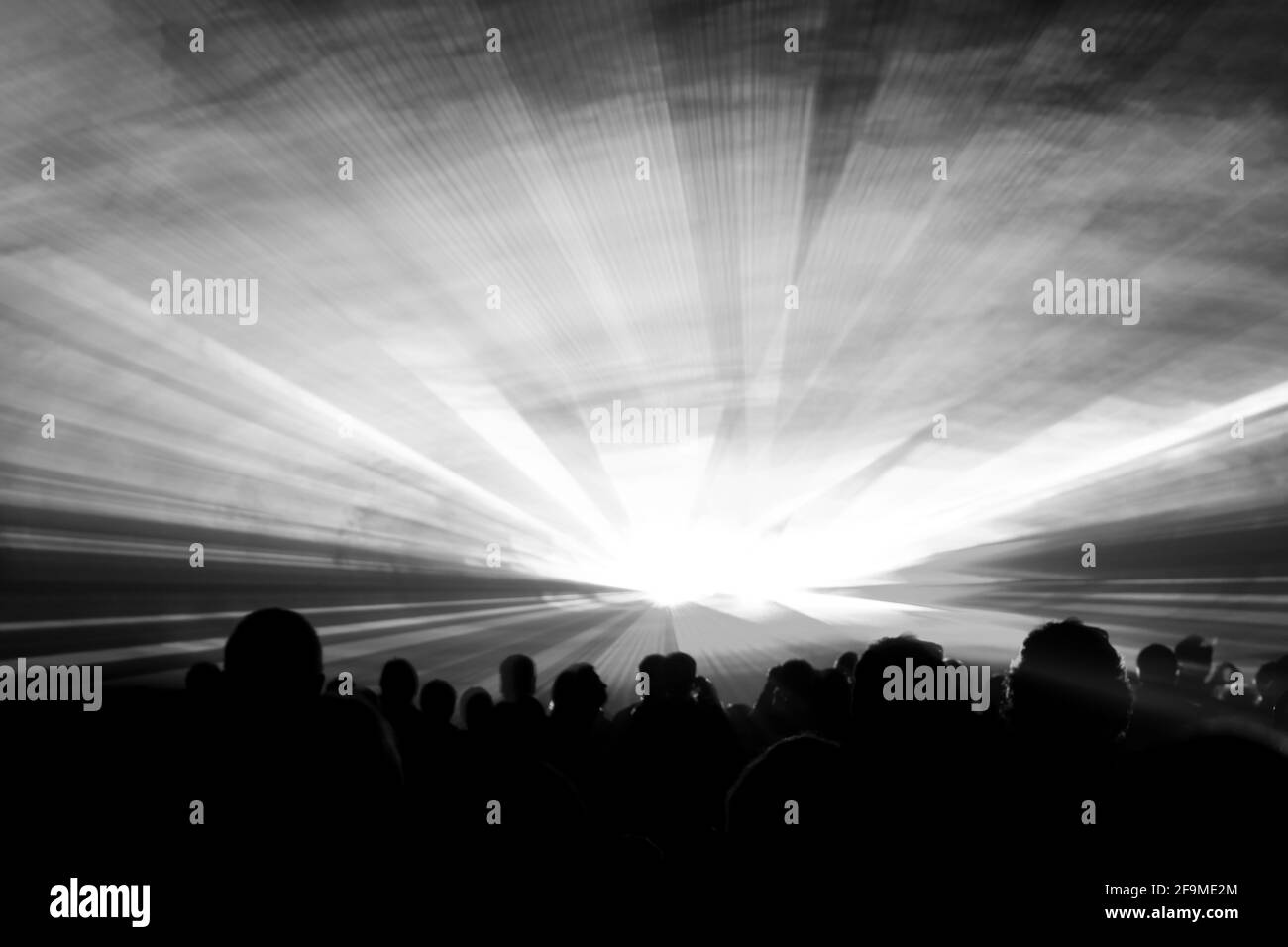 Grey laser show nightlife club stage with party people crowd. Luxury entertainment with audience silhouettes in nightclub event, festival or New Years Stock Photo
