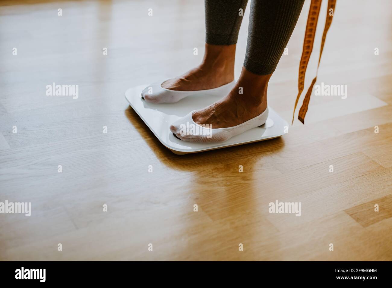 Woman Measuring Body Weight On Weighing Scale At Home Stock Photo Alamy